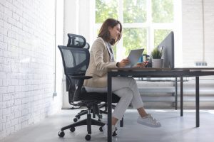 beautiful-caucasian-business-woman-is-working-using-digital-tablet-while-sitting-creative-office