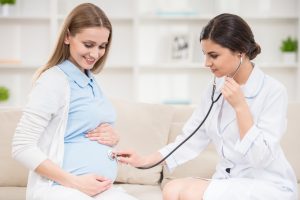 doctor-checking-pregnant-woman-tummy-with-stethoscope