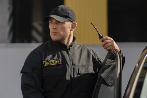 portrait-male-security-guard-with-radio-station-scaled